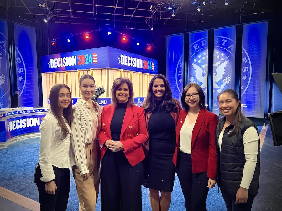 LMU External Relations team and student journalists from the Loyolan pose with news anchor Colleen Williams on set of the 2024 Senate Debate