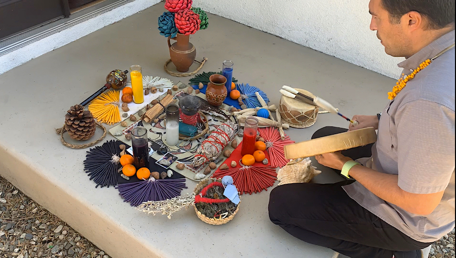 Ernesto Colin creates and altar and sings as part of a workshop