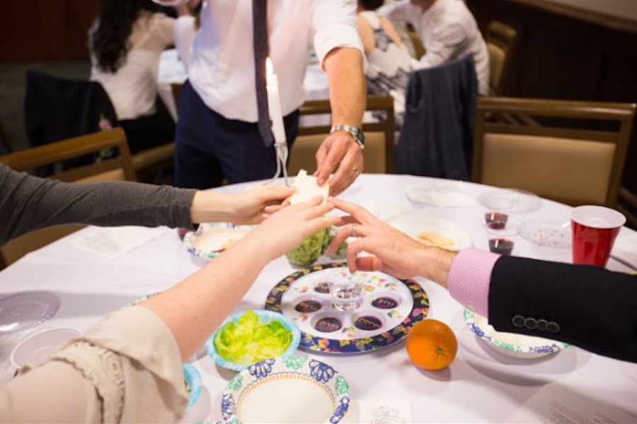 hands at a seder table