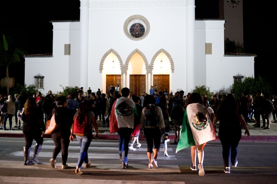 Students walk toward Sacred Heart Chapel for a rally in support of undocumented students